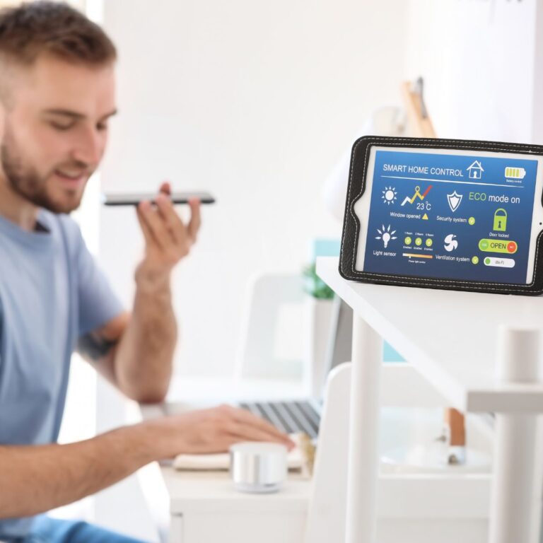 A person is using voice commands on a smartphone while exploring smart home ideas displayed on the nearby control screen.